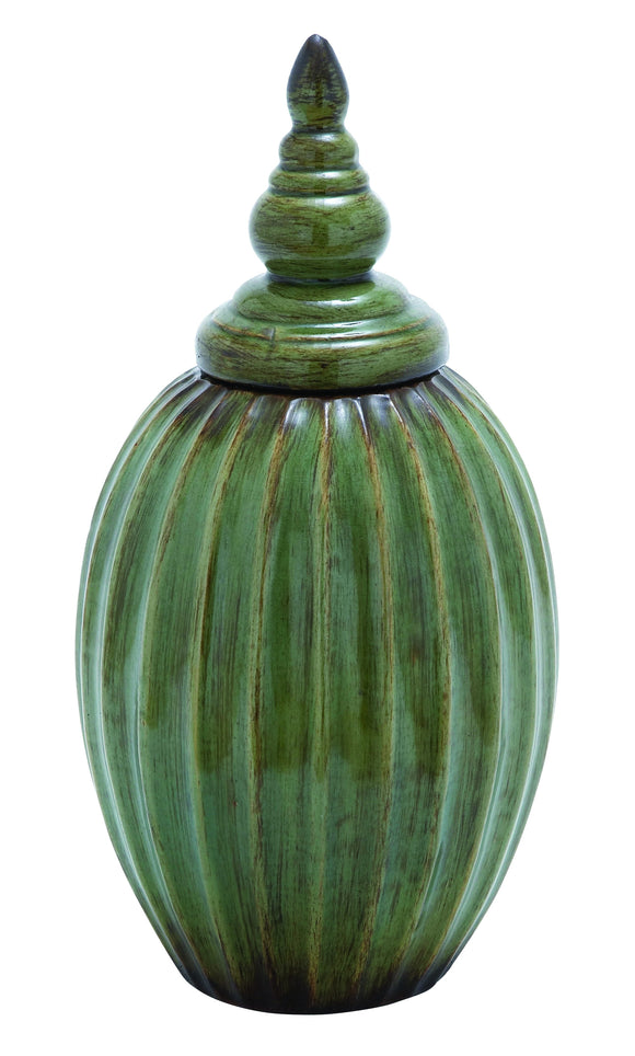 Ceramic Jar with Rusted Accents on a Green Background